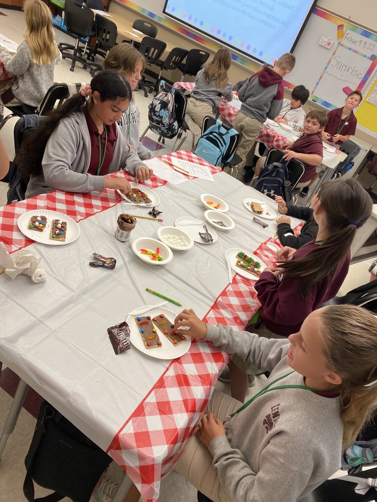 Students making dessert pizzas with decimals.