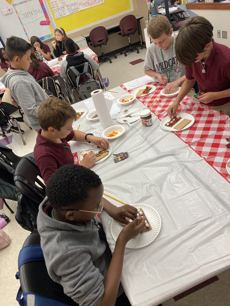 Students making dessert pizzas with decimals.