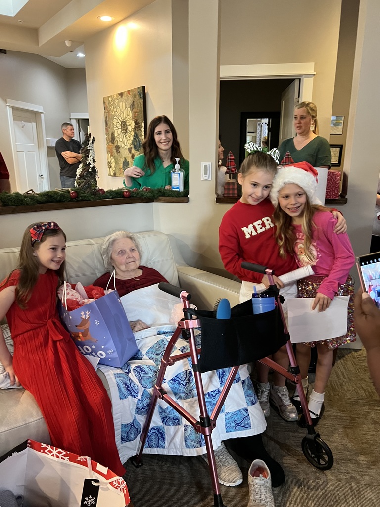 Students presenting gifts to residents.