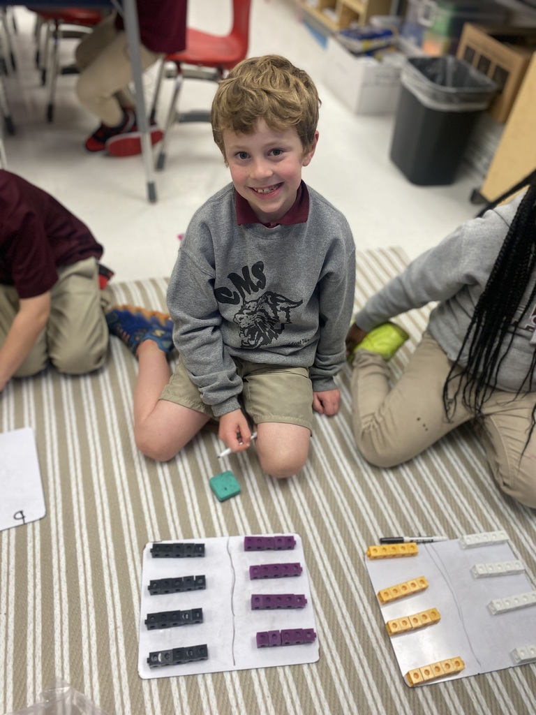 Students using cubes to count by tens